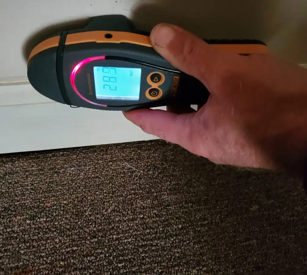 Moisture detection at baseboard during Storm Damage Restoration in Wildewood